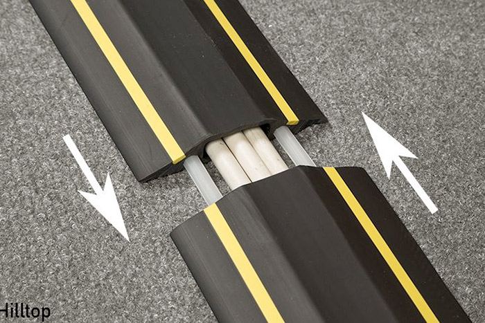 Cable curbs cover electrical cables to prevent tripping hazards.