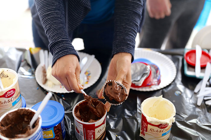 Students eat cupcakes at Dooley's Week events.