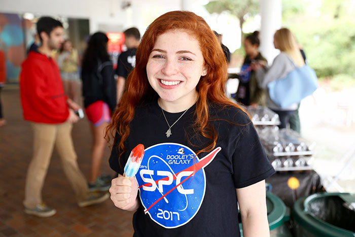 Students eat popsicles at Dooley's Week events.