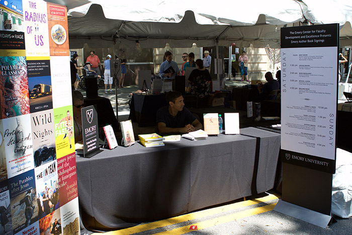 The Center for Faculty Development and Excellence table included a poster of all of the Emory authors' book jackets who would be signing books throughout the weekend.