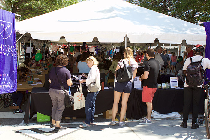 Five individuals visit Emory's tent in downtown Decatur.