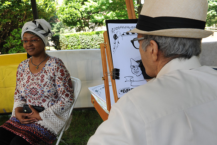 Staff members are drawn by a local artist at the 2017 Staff Fest.