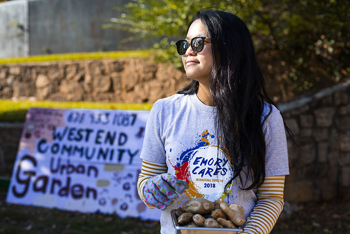 A student picks produce at the West End Community Garden