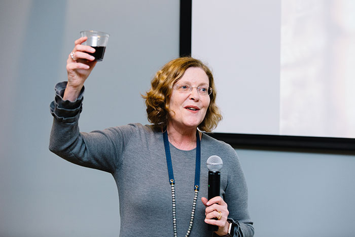 President Claire E. Sterk raises a glass at the Feast of Words