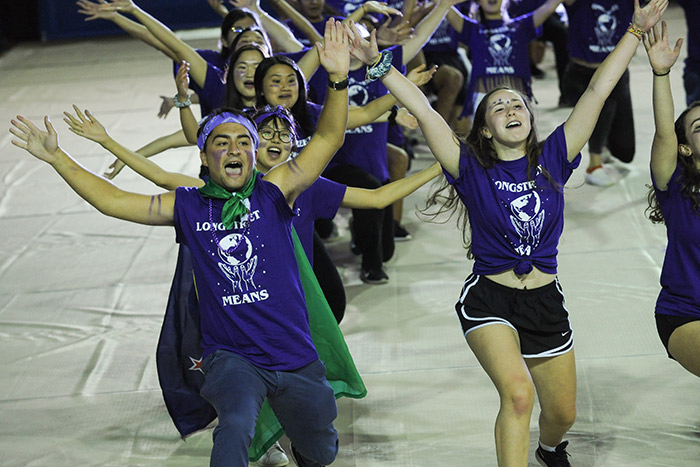 Students in purple t-shirts for the Longstreet Means residence hall dance and sing