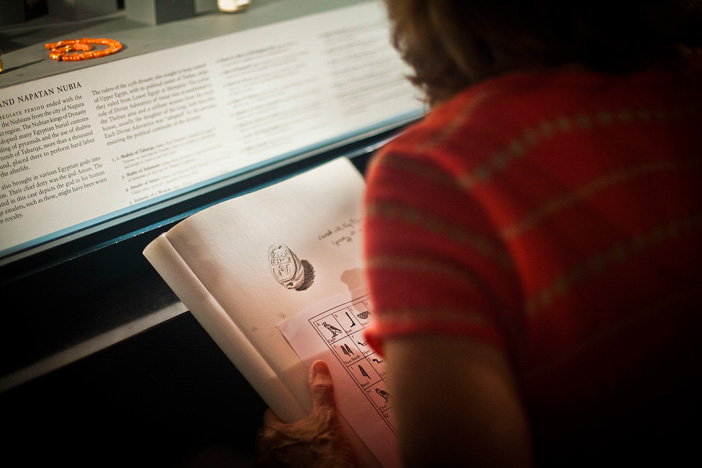 Ellen Childers draws objects exhibited in the Egyptian collection.