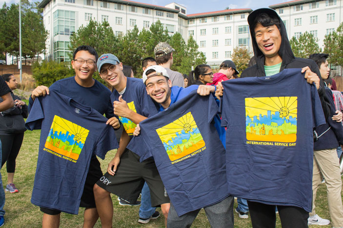 Students hold Emory Cares t-shirts