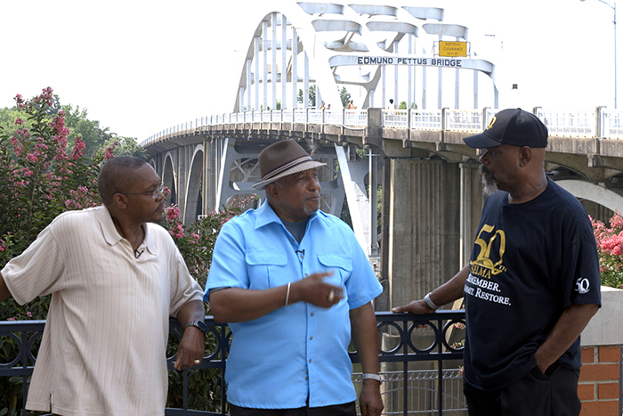 LaFayette (center) talks with two Selma, Alabama, residents at the foot of the Edmund Pettus Bridge.