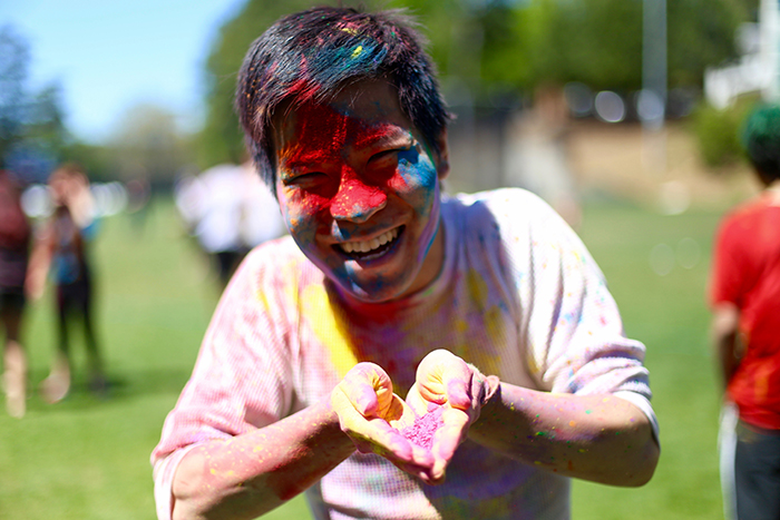 male holding colored powder