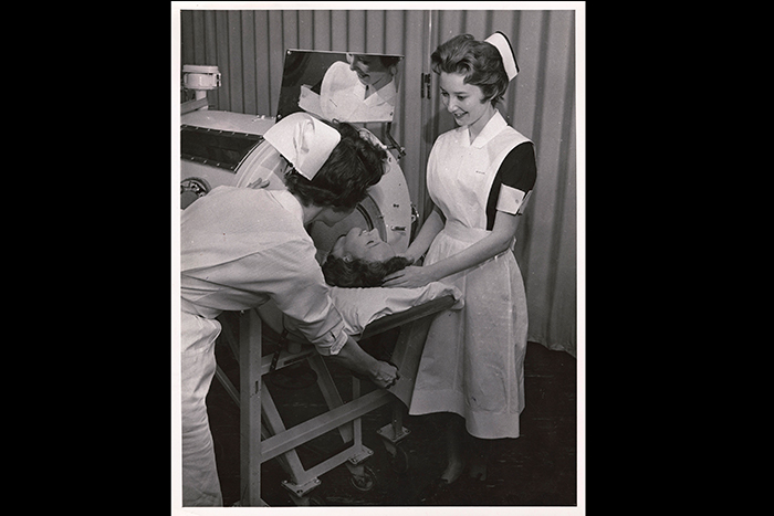 Nurses around an iron lung device in the 1960s. Image: Emory University Photograph Collection.