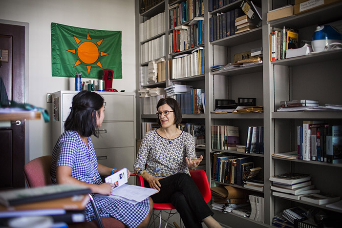 A professor and student talk in a professor's office