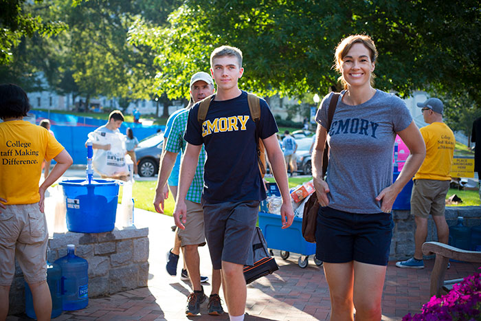 A new student is joined with his family on Move-In Day.
