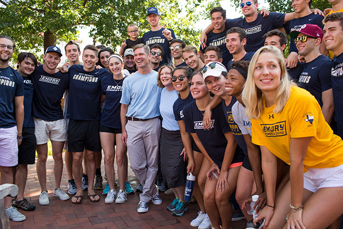 The Emory Swimming and Diving team poses with President Claire E. Sterk.