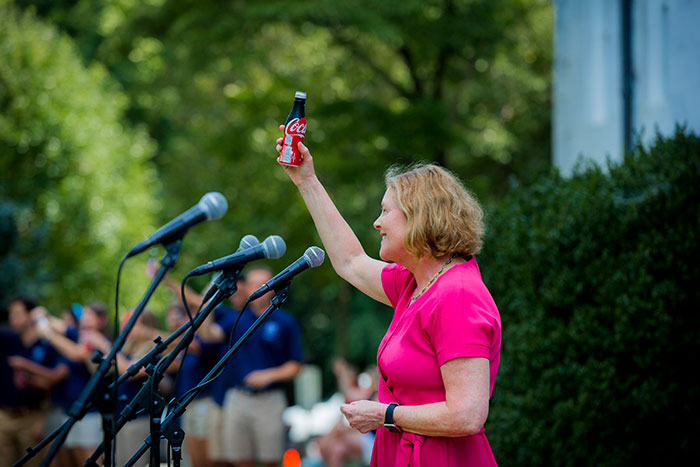 Emory President Claire E. Sterk raises a coke at the 2017 Coke Toast.