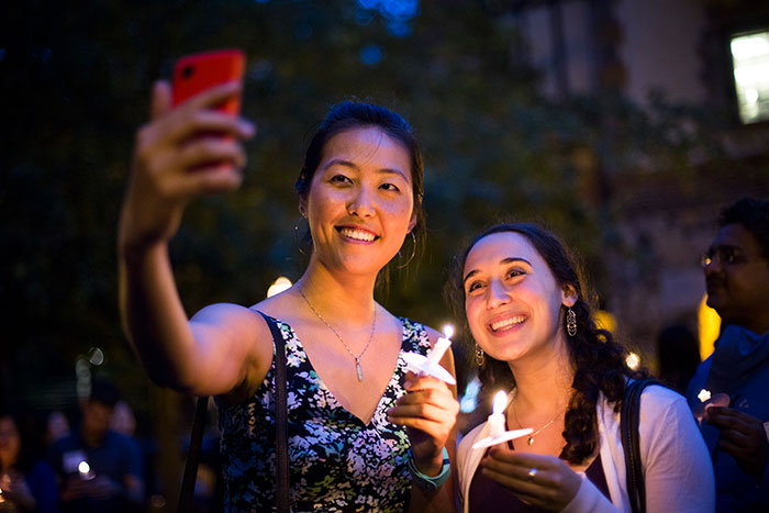 Students take a selfie as they cross the Emory bridge.
