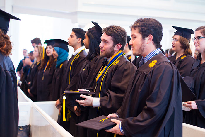 Oxford College students stand at the Oxford College Baccalaureate ceremony.