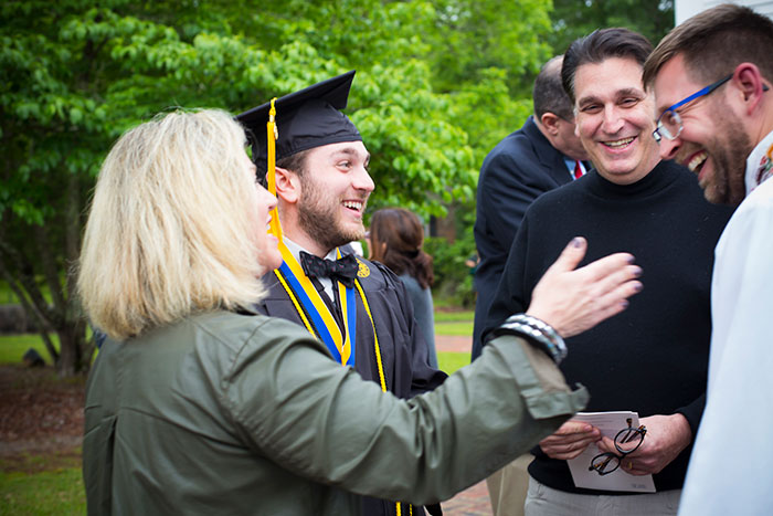 A student celebrates with family after the Oxford College Baccalaureate ceremony.
