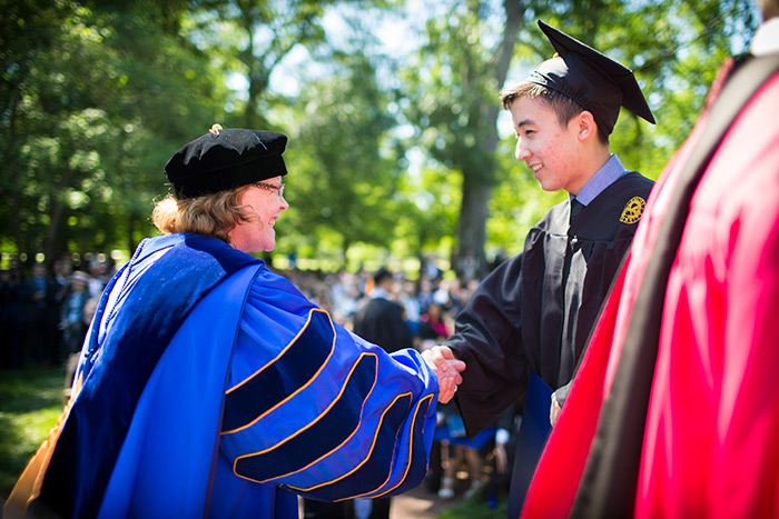 President Claire E. Sterk shakes a student's hand at Oxford College's 172nd Commencement.
