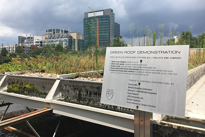 On the green roof on Facilities and Maintenance Building B, a sign explains that the three green roof systems evaluate and compare storm water retention, storm water quality, growth media, plant palette performance characteristics and comparative temperature readings.