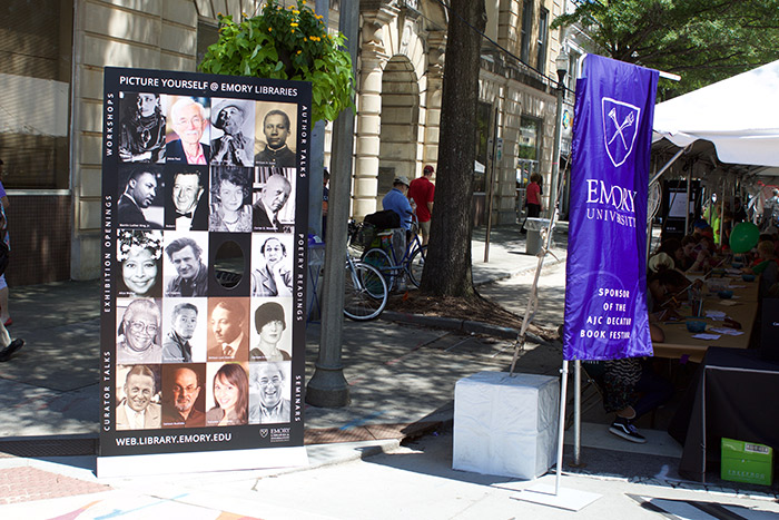 The Emory tent includes a banner of famous Emory authors.