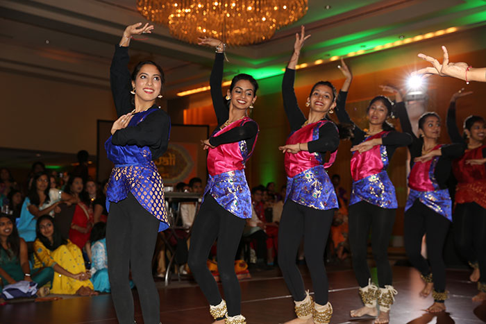 An all-female dance team performs a dance.