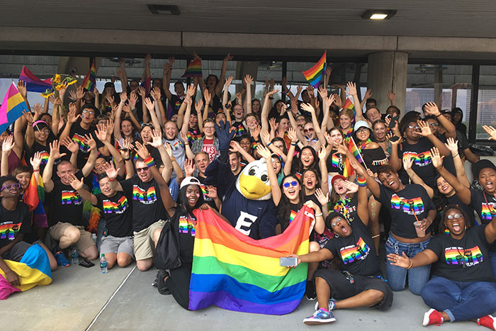 A large contingent from Emory poses and cheers at the Atlanta Pride Parade.