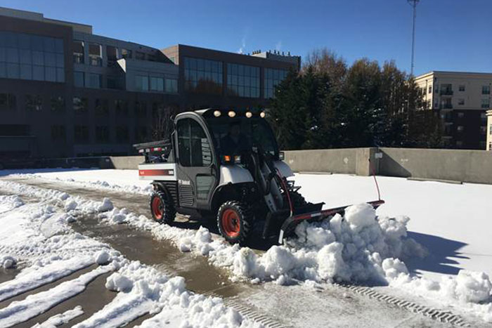 Campus Services staff work to remove snow from roads and walkways.