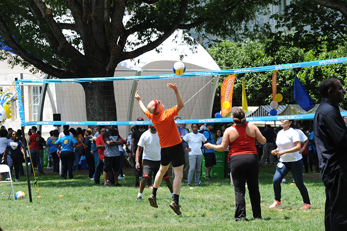 Staff members play volleyball at the 2017 Staff Fest.