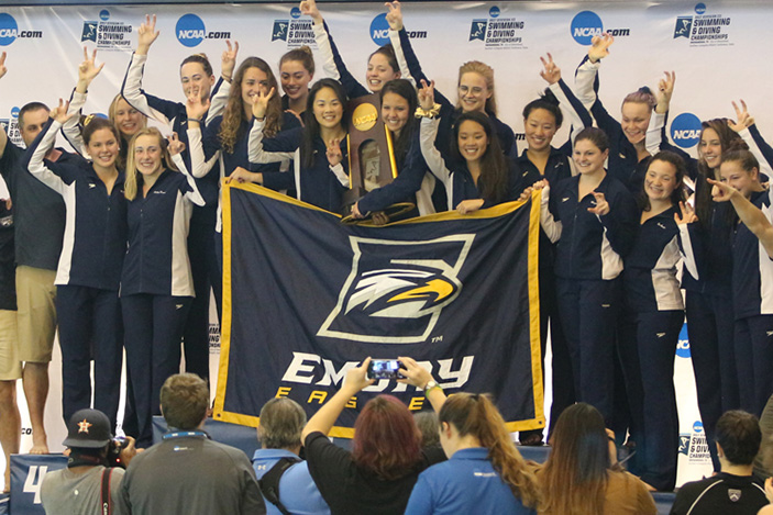 The Emory women's team stands together as the team claimed its eighth consecutive NCAA Division III Championship.