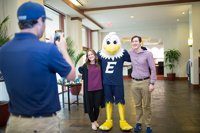 Students pose with Swoop at the unveiling of the new Swoop statue at the Emory Conference Center Hotel.