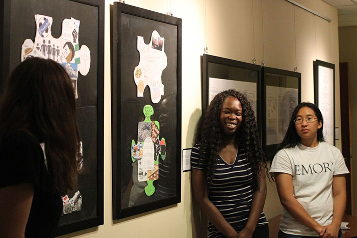 Students look at art in the class gallery.