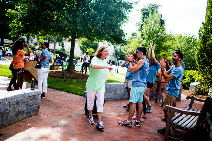 Emory President Claire Sterk with students on Move In Day