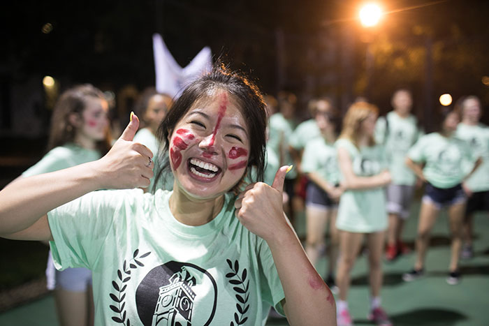 A student wearing face paint smiles