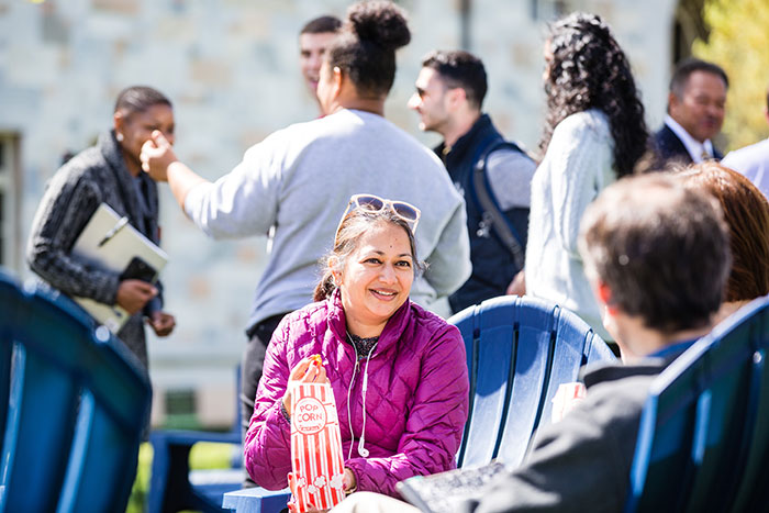 An Emory community member eats popcorn, one of the light snacks available, at Conversations on the Quad