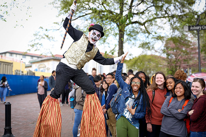 A performer stands on stilts at Dooley's Week