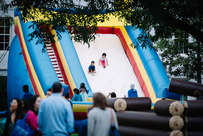 Children slide down an inflatable slide at the Homecoming Festival