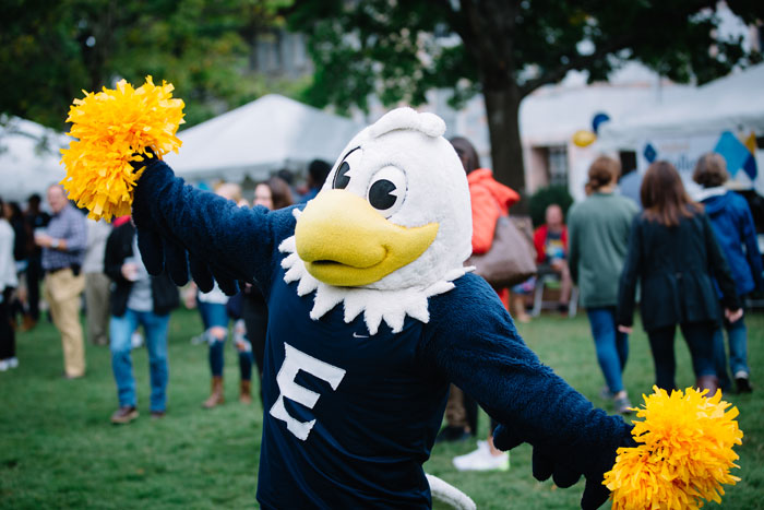 Emory mascot Swoop holds pom-poms at the Homecoming Festival