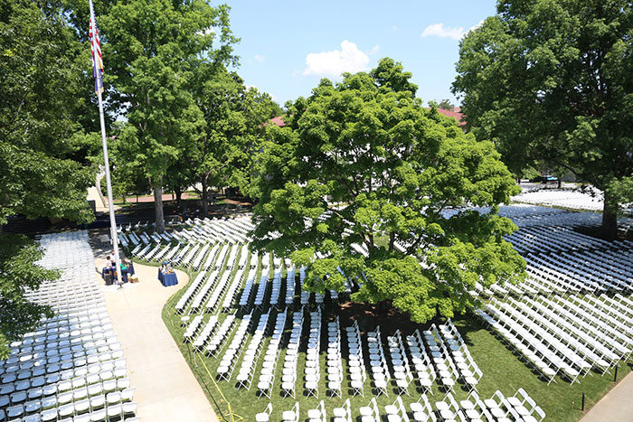 A wide angle photo shows all the chairs set up on the quad