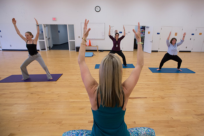 Employees participate in a yoga class