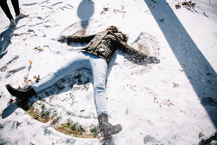 A student makes a snow angel
