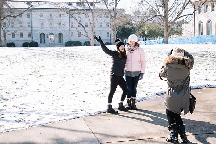Students pose for pictures in the snow