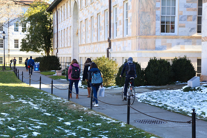 Students walk and ride bicycles across campus