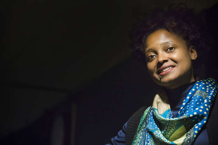 Tracy K. Smith poses in front of a black backdrop