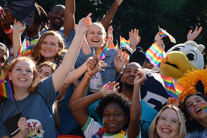 A group of Emory students will cheer, waving small rainbow flags