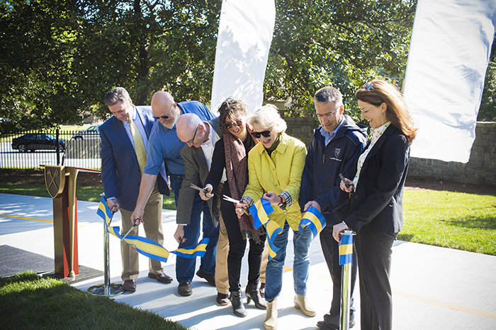 Seven representatives of Emory, the PATH Foundation and the City of Atlanta cut a large blue and yellow ribbon to officially open the new path.