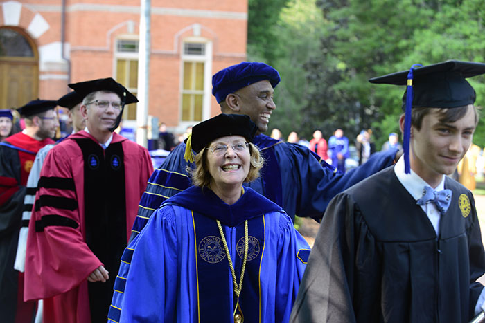 Emory President Claire E. Sterk and Provost Dwight A. McBride walk in the Commencement procession