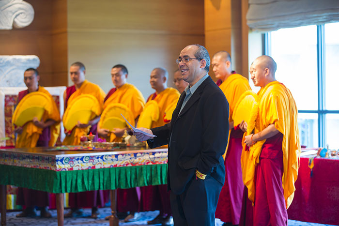 At the traditional opening ceremony, Geshe Lobsang Tenzin speaks while the monks of the Drepung Loseling Monastery of Atlanta stand behind him