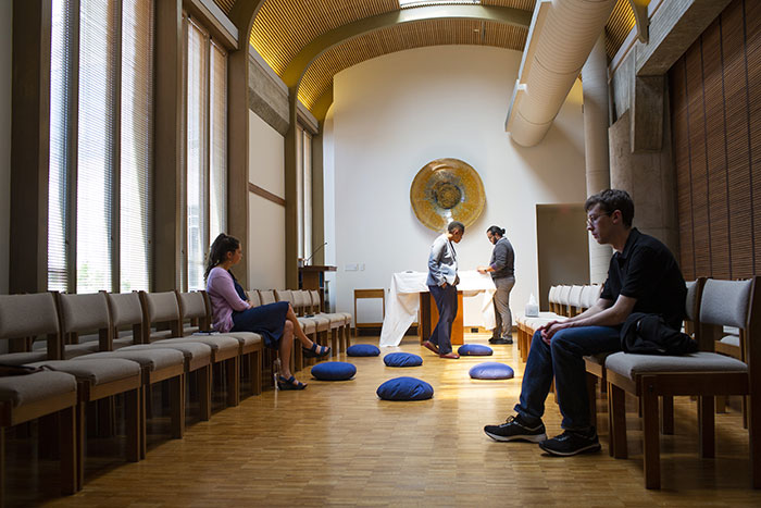 Students sit reflectively in Cannon Chapel