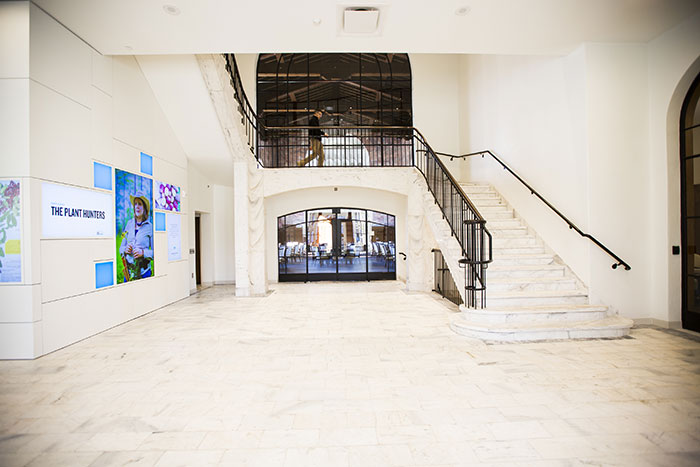 An interior view of the foyer highlighting the 100-year-old marble stairs and digital displays