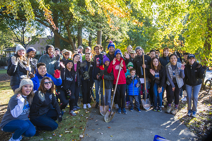 Students pose for a photo with shovels